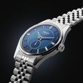 A sleek silver and blue watch mens with a rich blue dial and a silver bracelet featuring a five-row link chain.