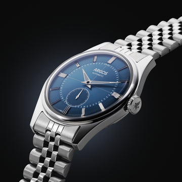 A sleek silver and blue watch mens with a rich blue dial and a silver bracelet featuring a five-row link chain.
